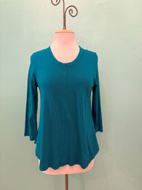 Front view of a teal 3/4 sleeve women's top on a mannequin against a light background