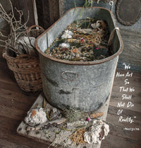 Rustic metal tub filled with botanicals and quote about art by Nietzsche