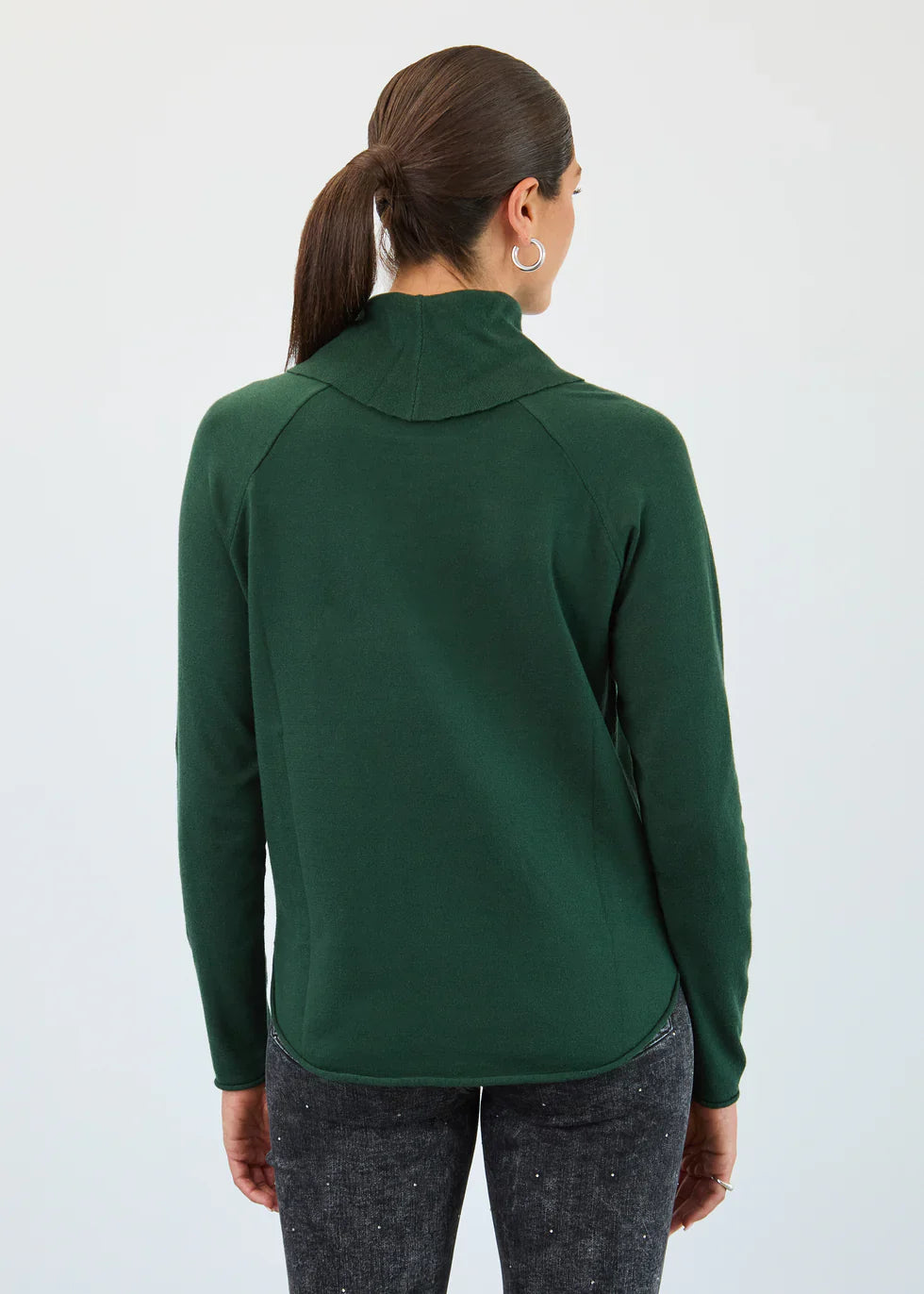 Back view of a woman wearing a green pullover top with long sleeves