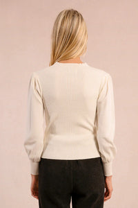 Back view of ivory knit sweater with ribbed texture and puff sleeves
