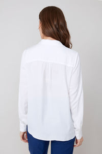 Back view of white button-up blouse with long sleeves