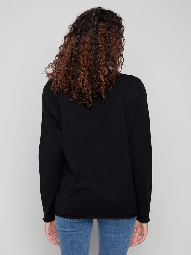 Back view of a woman modeling a black V-neck sweater