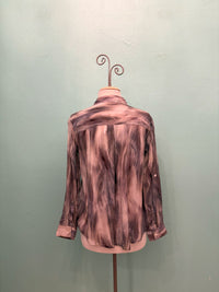 Back view of smoky marble pattern sheer blouse displayed on mannequin