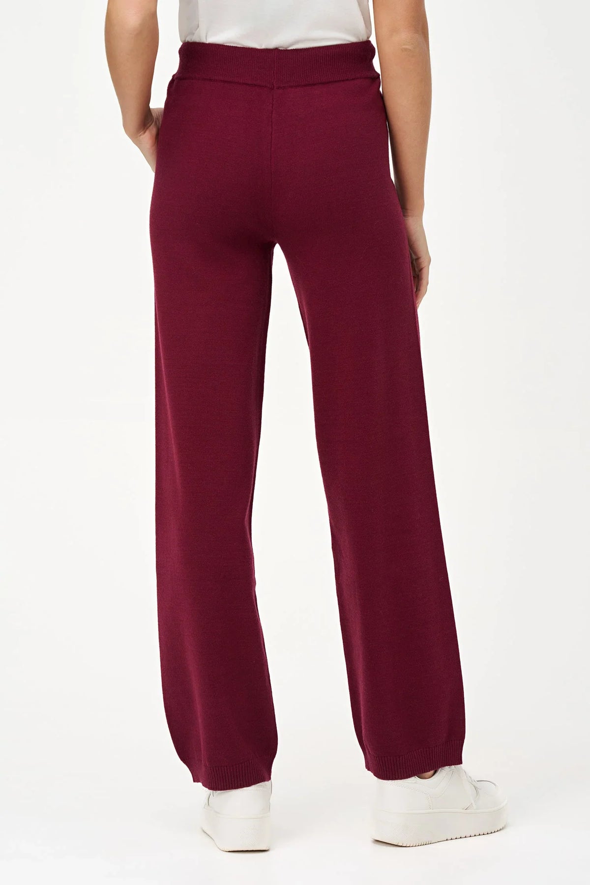 Back view of woman wearing burgundy relaxed-fit knit jogger pants