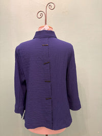 Rear view of indigo textured jacket displaying back button details