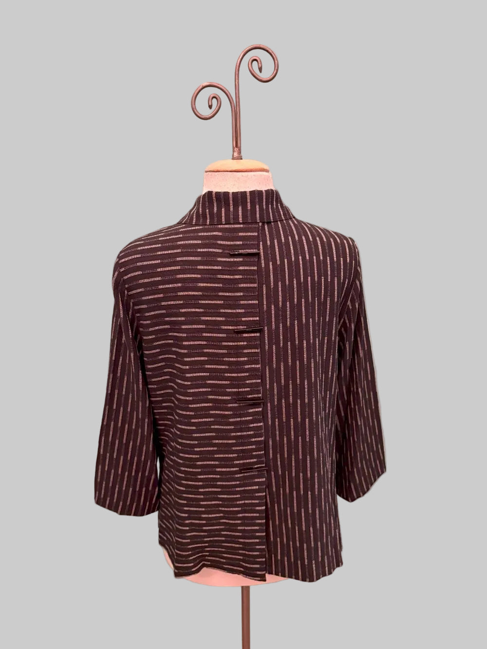 Back view of brown and beige striped kimono-style jacket with contrasting stripe directions