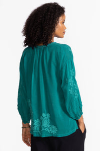 Back view of teal blouse with floral embroidery and gathered details