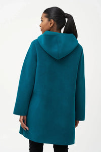 Back view of teal wool hooded coat on model