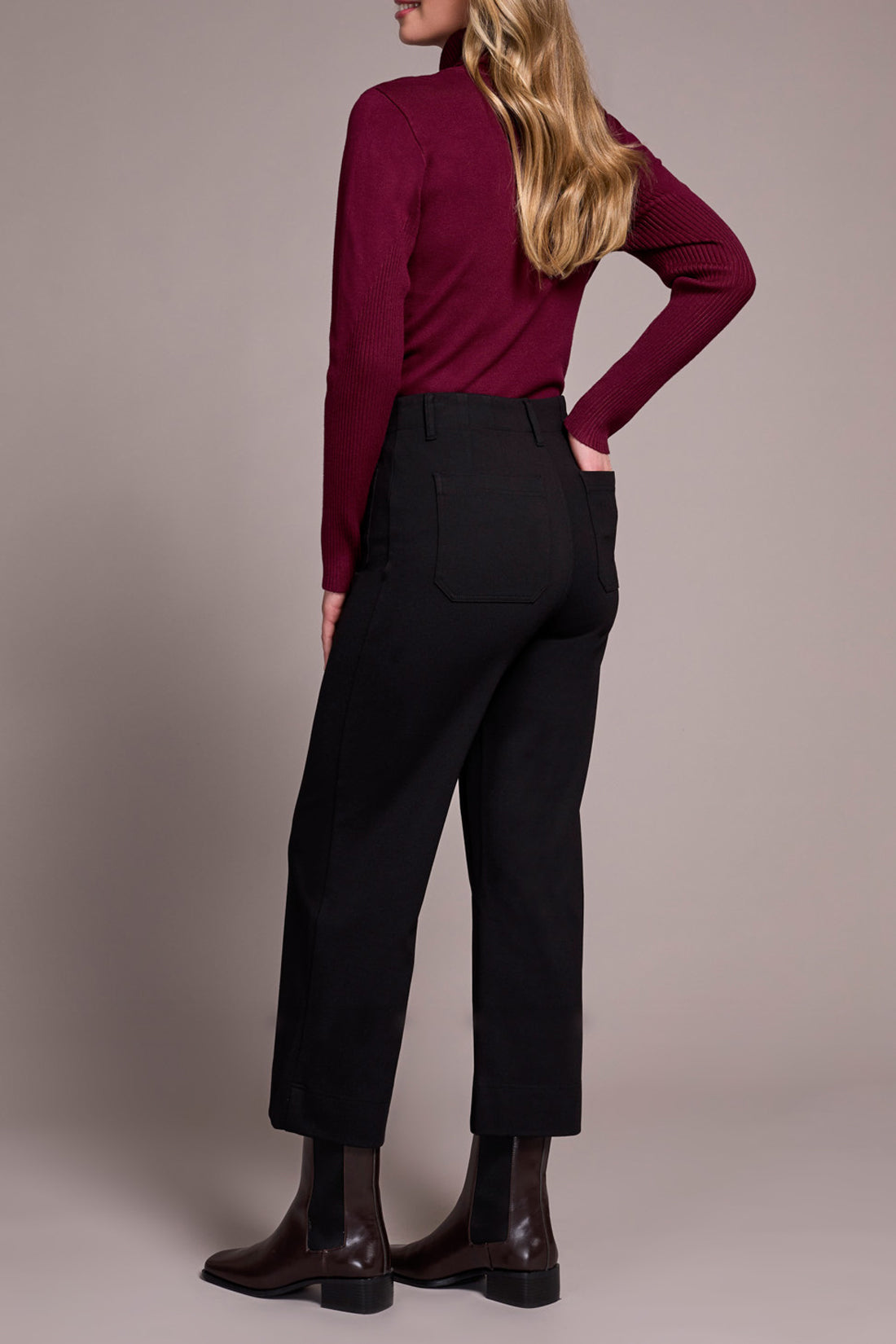 Back view of wide-leg black dress pants on model