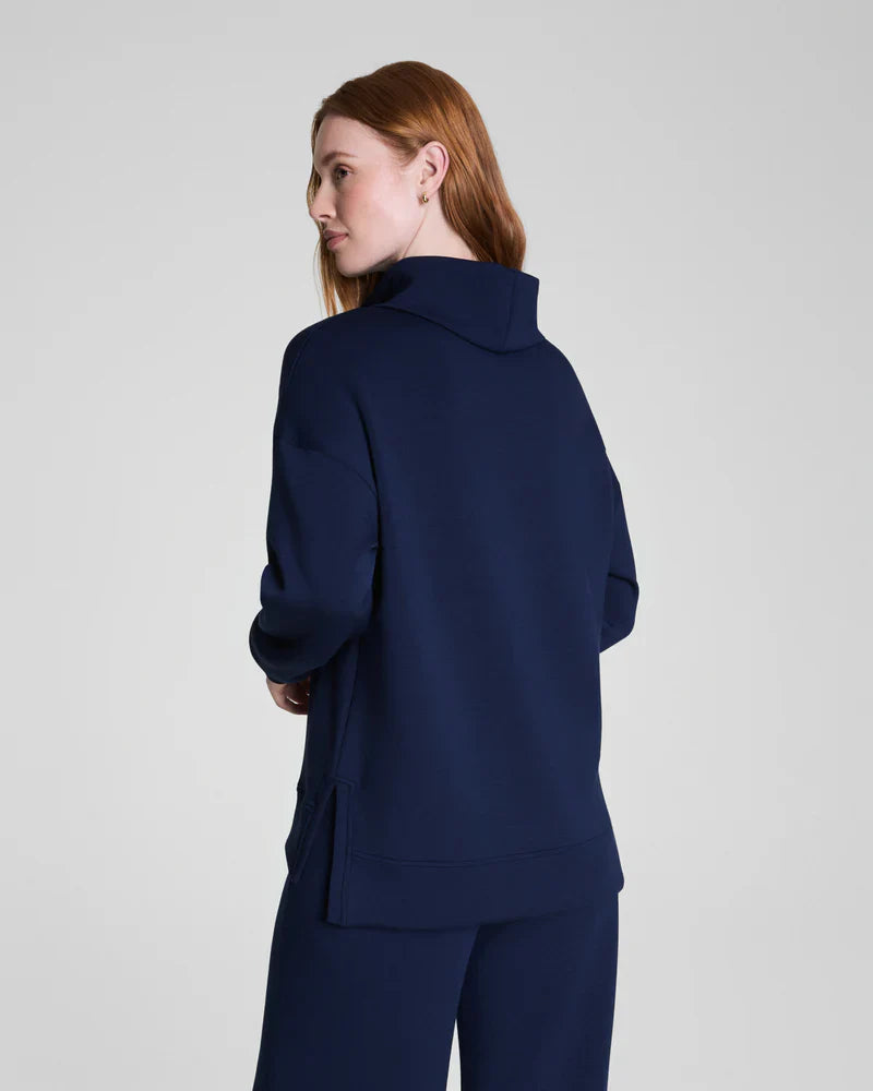 Model displaying the back silhouette of navy mock neck lounge sweatshirt