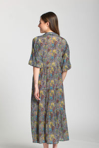 Profile view of woman wearing a grey garden-inspired midi dress