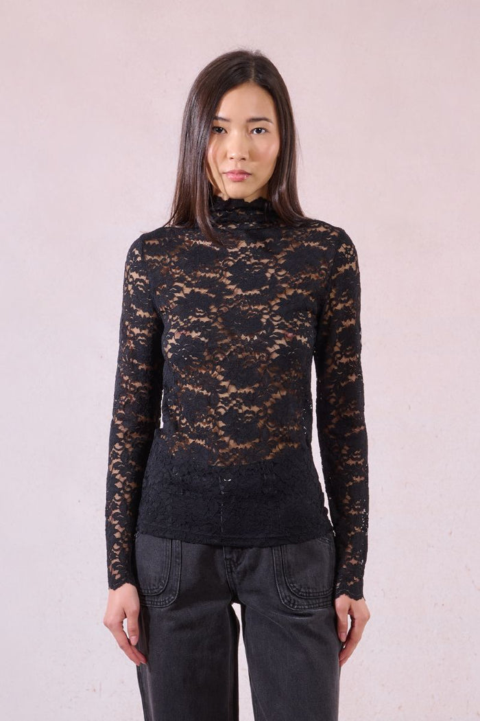 Front view of model wearing a black sheer lace turtleneck top with long sleeves