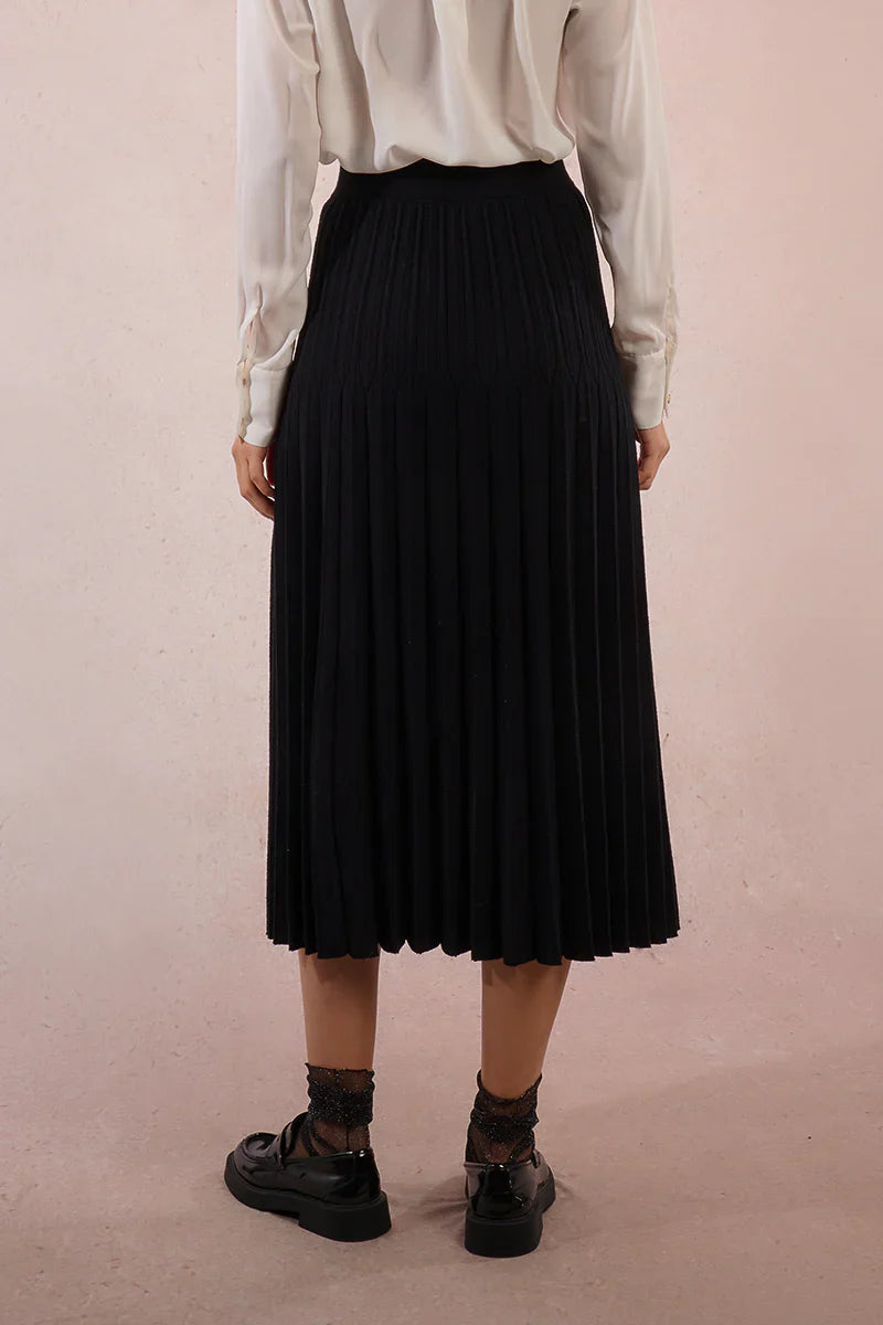 Back view of black knit pleated midi skirt with detailed waistband