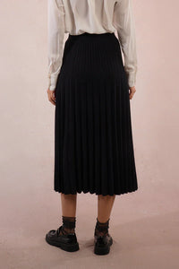 Back view of black knit pleated midi skirt with detailed waistband