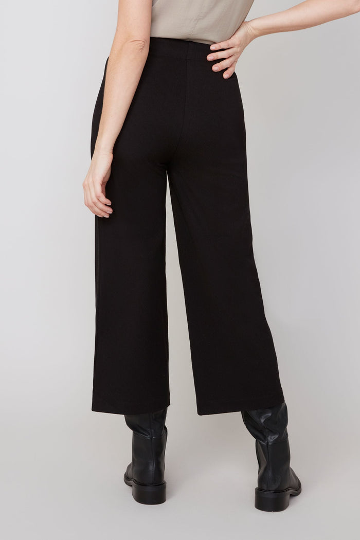 Back view of black wide-leg cropped pants highlighting high waist design