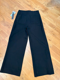 Back view of wide-leg black dress pants on model