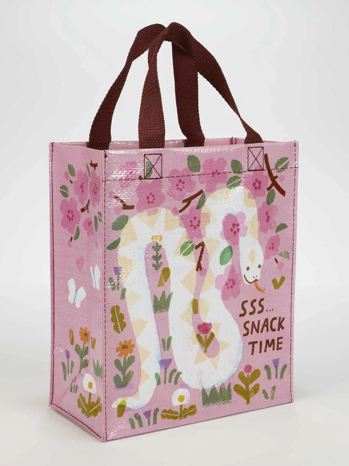 Front view of pink tote bag featuring a white snake, flowers, and 'SSS... SNACK TIME' text