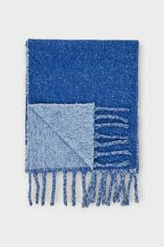Blue knit scarf with light blue corner detail and fringe ends