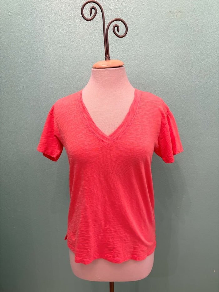 Front view of a bright coral V-neck t-shirt displayed on a mannequin
