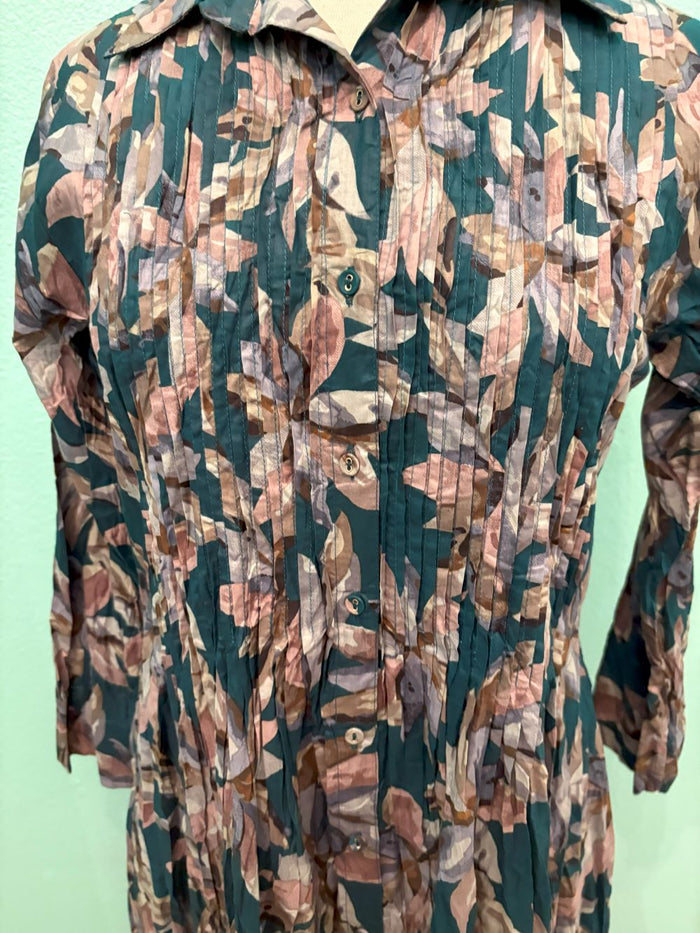Front button-up detail and pleated texture on nature-inspired leaf print dress