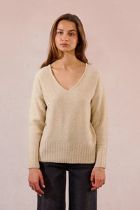 Front view of woman modeling a champagne sequin V-neck sweater