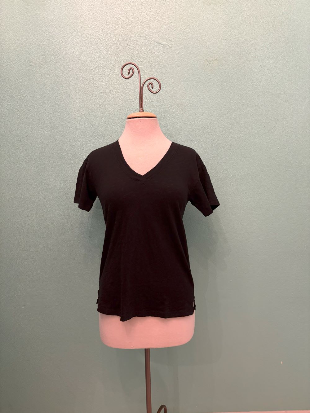 Front view of a classic black V-neck short sleeve women's t-shirt on a mannequin