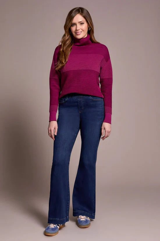 Front view of woman standing in classic high-rise bootcut jeans