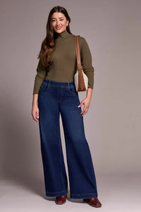 Front close-up of model wearing high-rise wide leg jeans and olive turtleneck