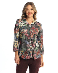 Front view of woman in autumn-inspired floral button-up blouse with long sleeves