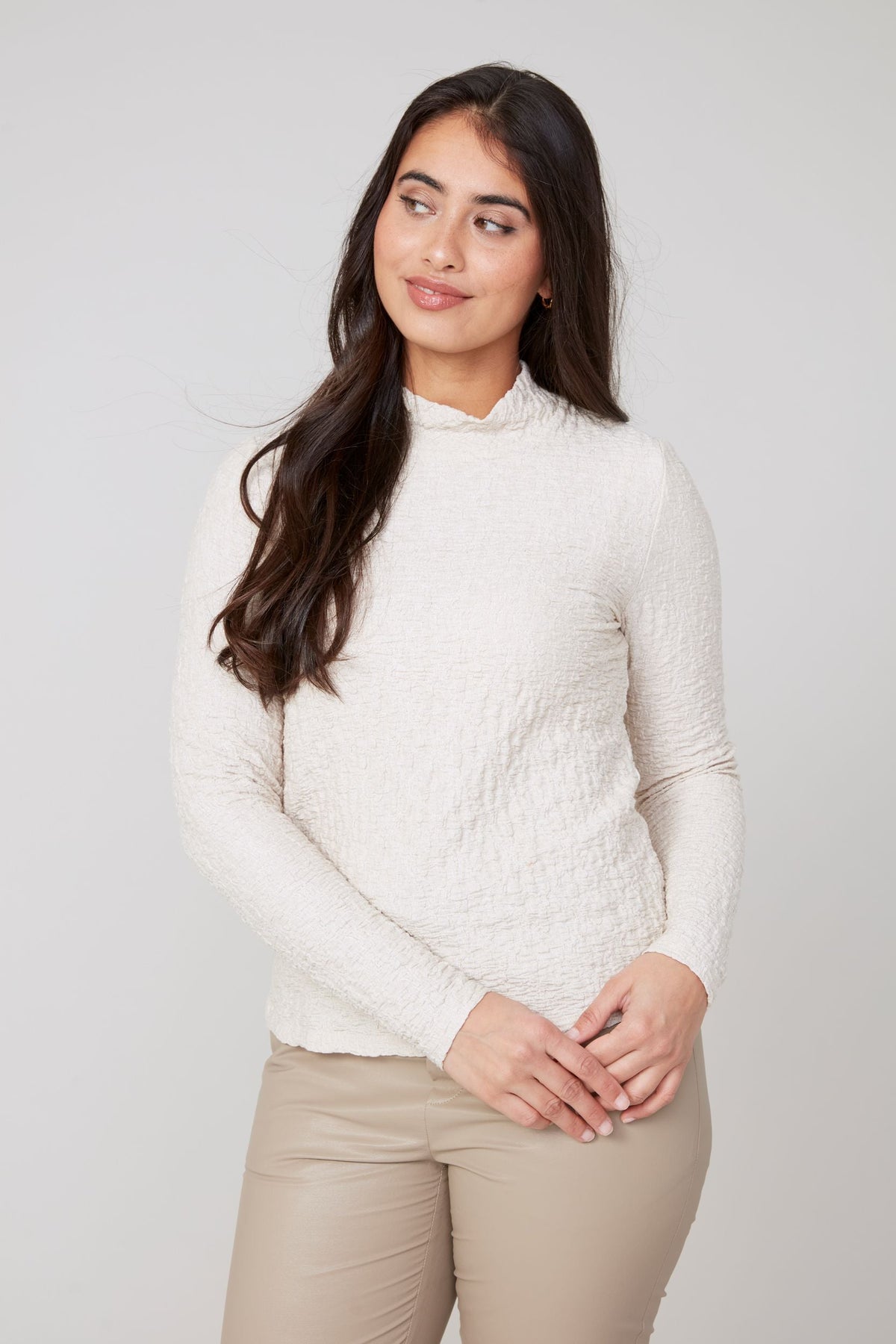 Close-up front view highlighting mock neck detail and soft texture of ivory top