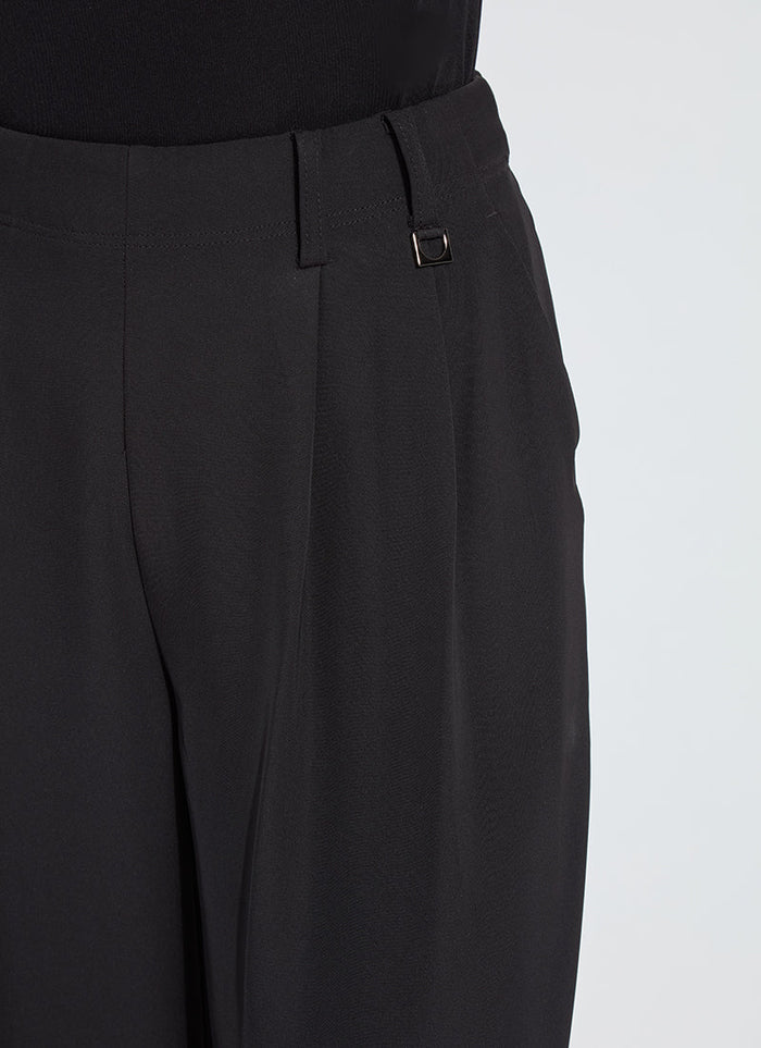 Close up view of high waist detail on black wide leg trousers