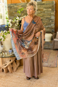 Full length view of woman modeling a blue vase butterfly art print scarf in a cozy room