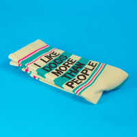 Pair of cream gym socks with teal, pink stripes, and 'I Like Dogs More Than People' text