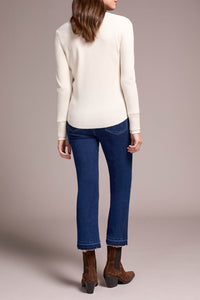 Back view of cream waffle knit henley top paired with blue cropped jeans and brown suede boots