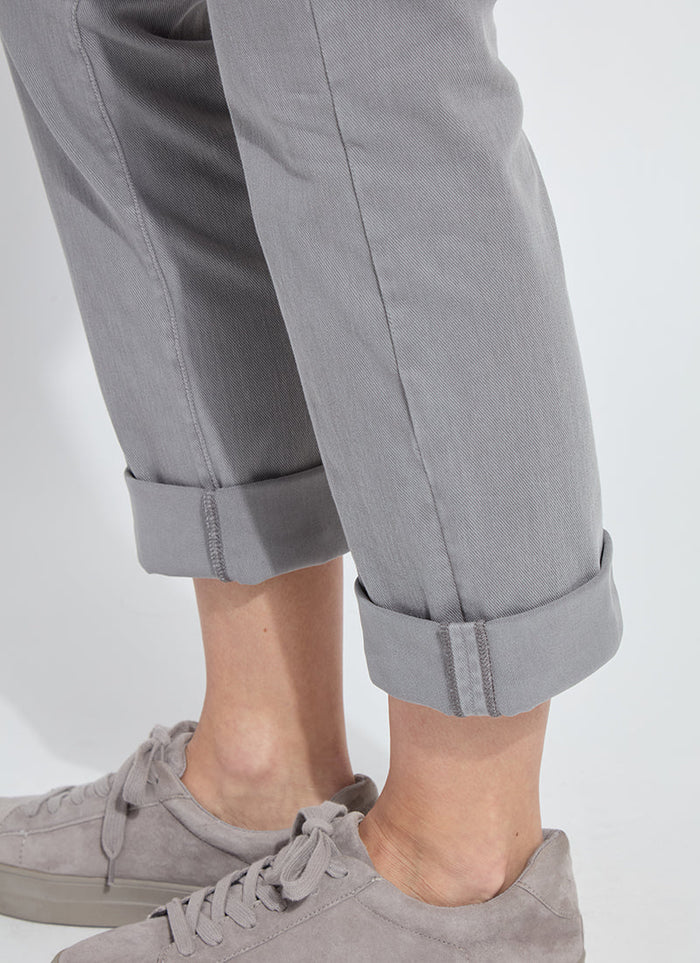 Close-up of women's grey rolled cuff pants and matching grey sneakers