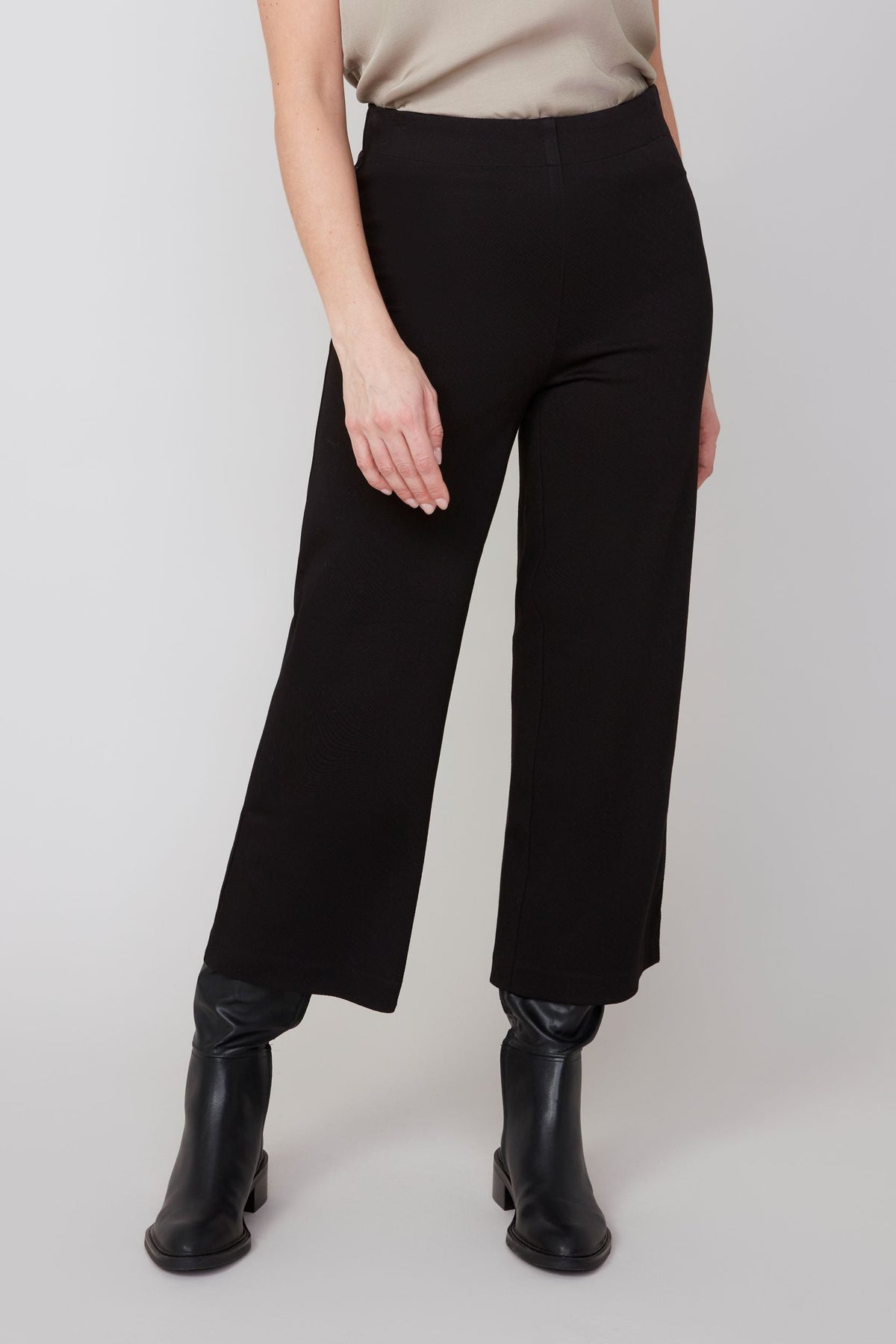 Close-up of wide-leg cropped pants paired with black ankle boots