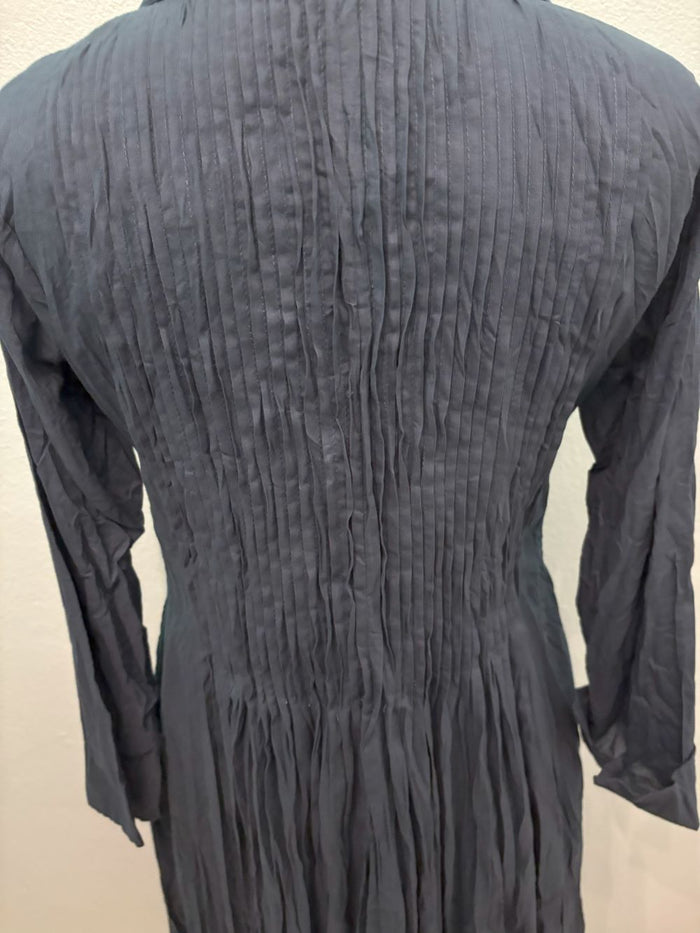 Close-up of back pleats on midnight blue long sleeve dress