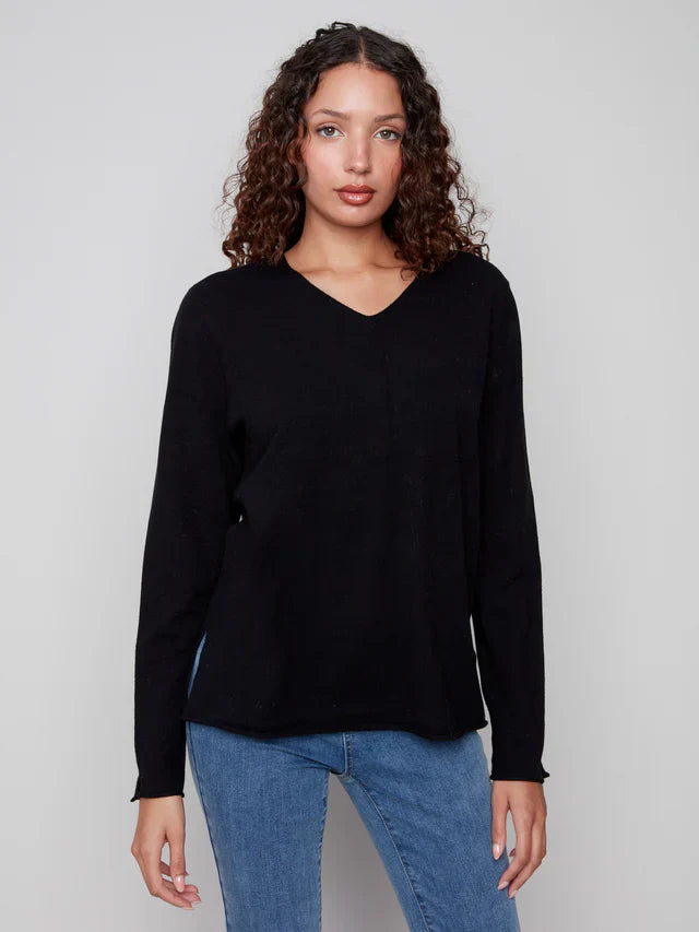 Close-up front view of black V-neck sweater on a woman