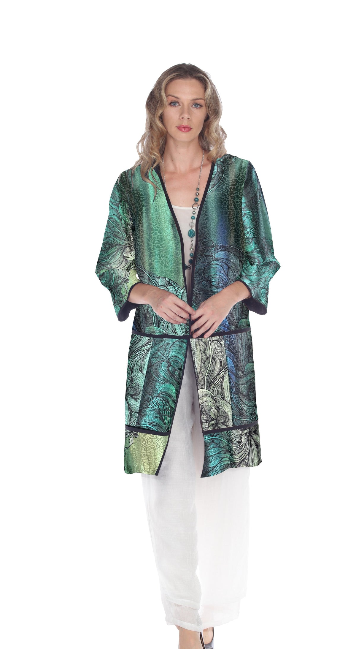 Woman wearing a vibrant green and blue patterned kimono jacket over white clothing