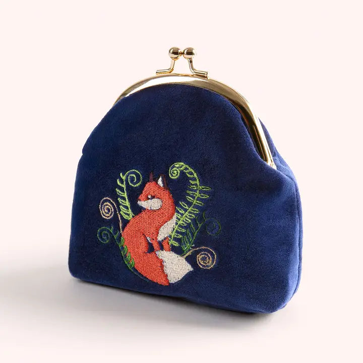 Close-up of blue velvet coin purse with embroidered fox and foliage design