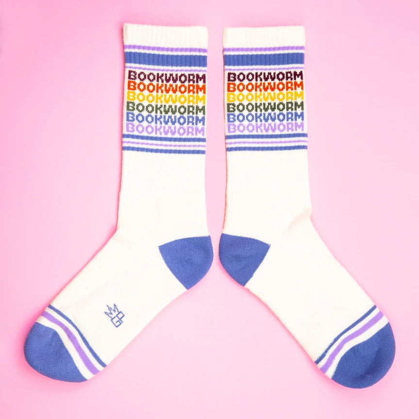 Pair of Bookworm rainbow gym socks displayed flat, featuring purple toes and striped cuffs