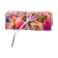 Closed floral travel jewelry organizer secured with lavender ribbon