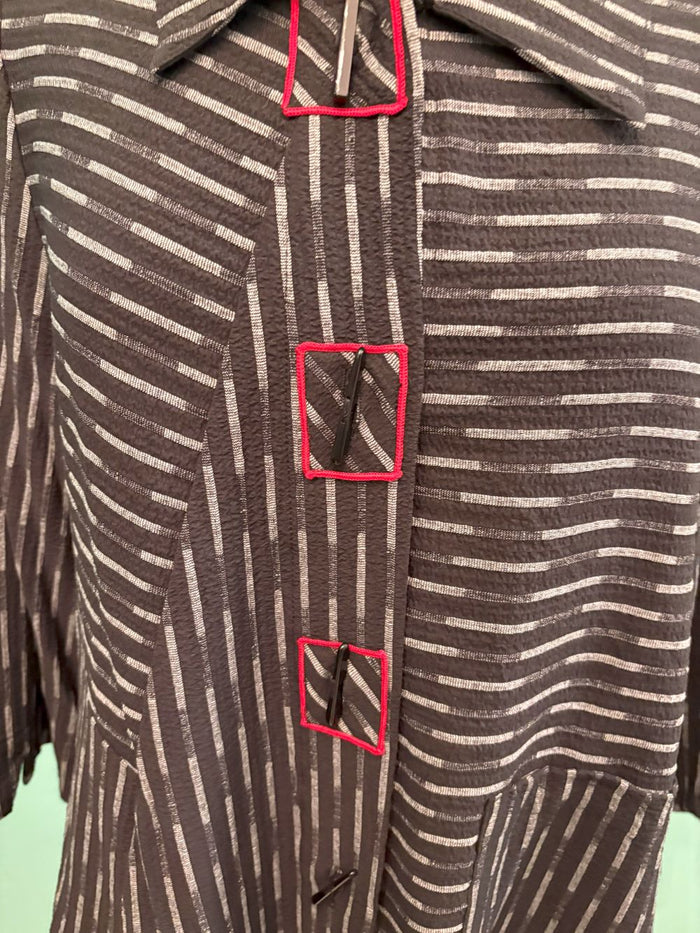 Detailed close-up of front buttons and red-stitched buttonholes on a striped jacket
