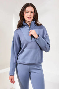 Front view of model in cloud blue lounge set, showcasing half-zip pullover and fitted pants