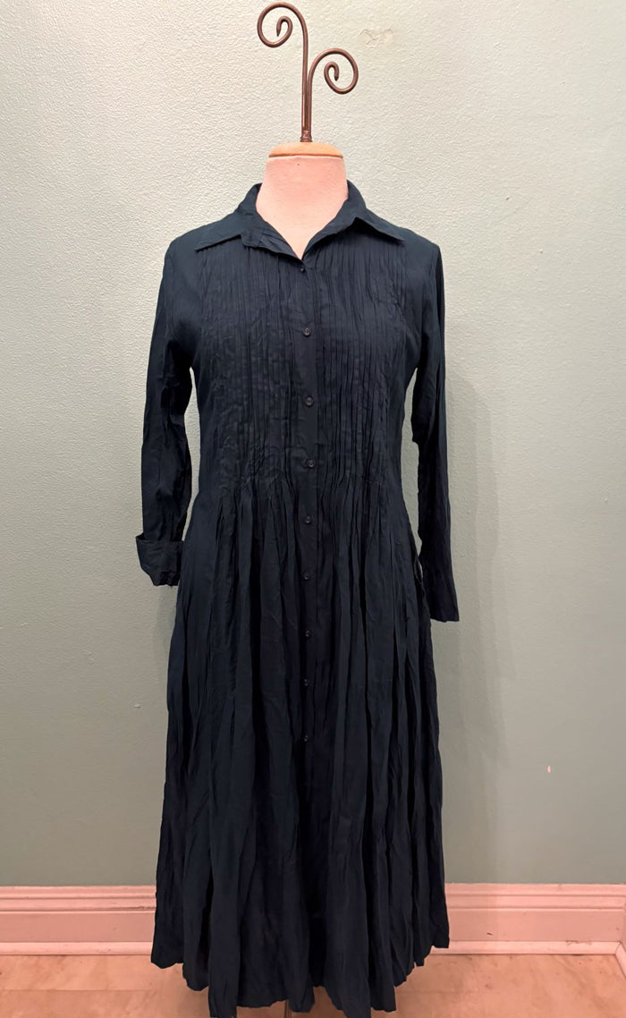 Front view of midnight pleated button-up midi dress with collar and long sleeves
