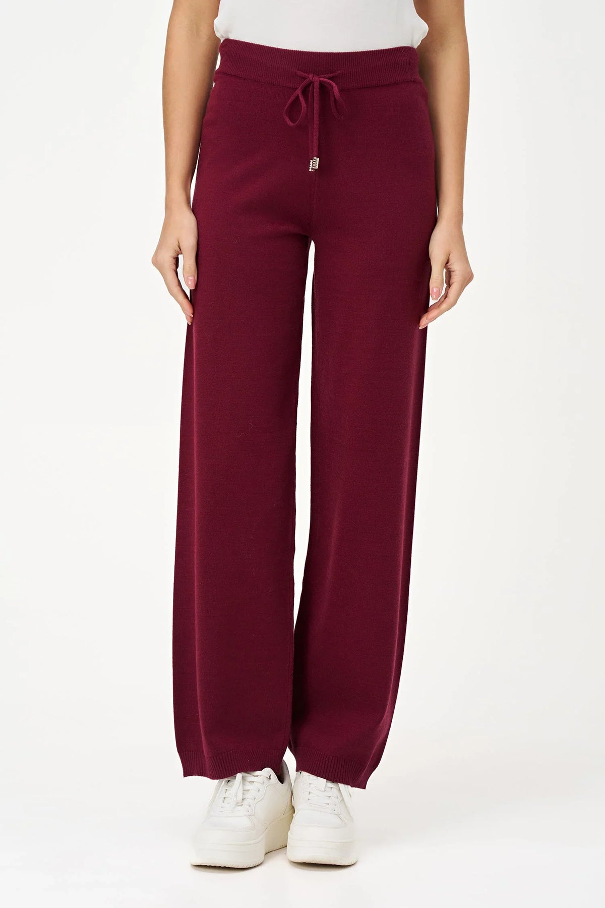 Front view of woman wearing burgundy relaxed-fit knit jogger pants with drawstring