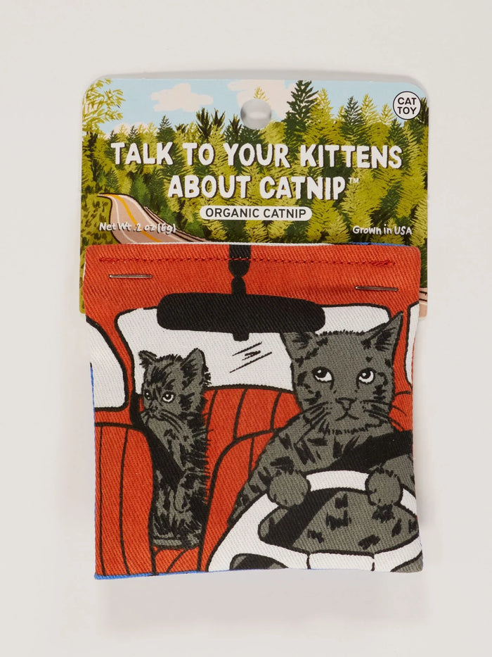 Front of Blue Q catnip toy pouch featuring cartoon cats driving with 'Talk To Your Kittens About Catnip' text