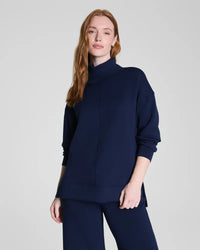 Full front view of model wearing navy mock neck lounge sweatshirt and pants