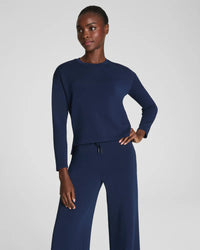 Front view of woman modeling a navy long-sleeve top with matching pants