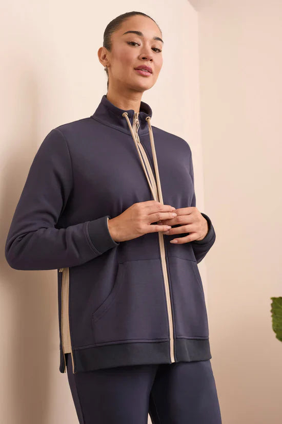 Front upper body view of woman showing full zip midnight blue jacket